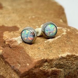 Sterling silver and opal stud earrings.